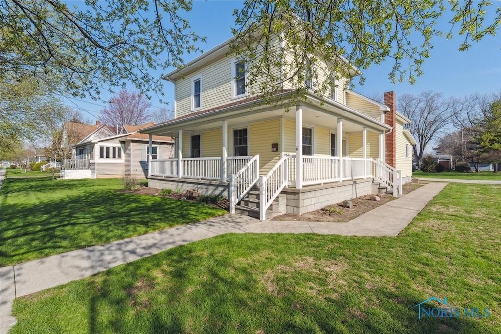 316 Stryker St, Archbold, OH 43502 - country-style home featuring a porch, a front lawn, and a chimney