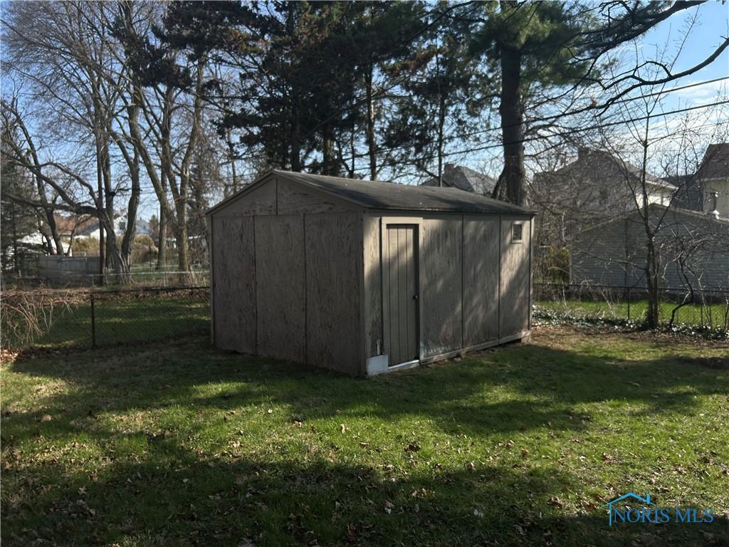 view of shed with fence