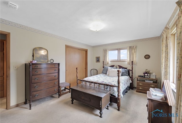 bedroom with light colored carpet and baseboards