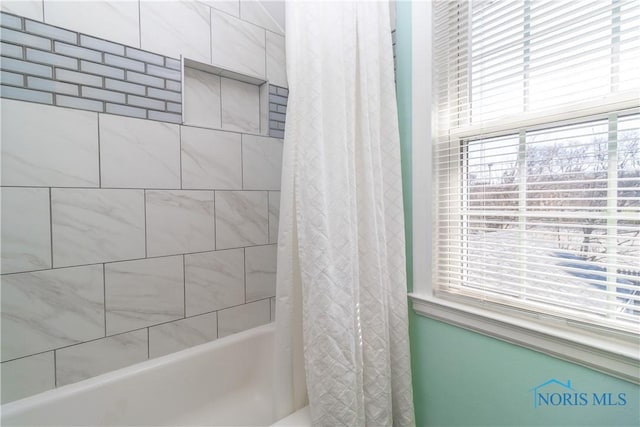 full bath with shower / bath combination with curtain