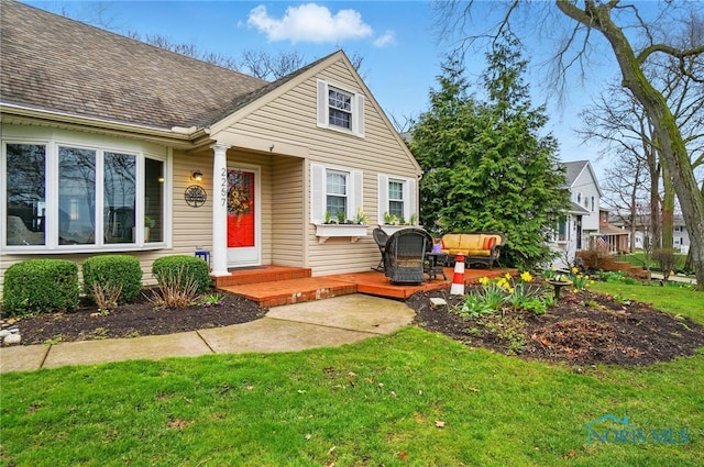 2257 N Carriage Ln, Port Clinton, OH 43452 - view of front of house with a shingled roof and a front yard