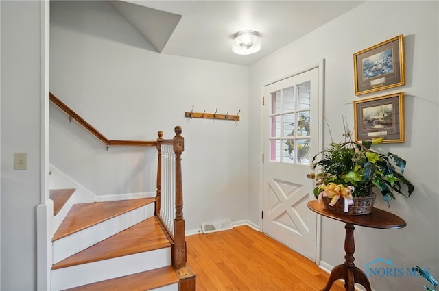 2257 N Carriage Ln, Port Clinton, OH 43452 - entryway with visible vents, baseboards, light wood-type flooring, and stairs