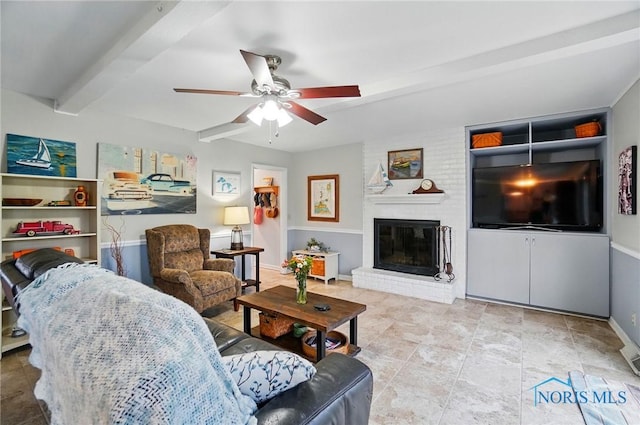 2257 N Carriage Ln, Port Clinton, OH 43452 - living room featuring beamed ceiling, a brick fireplace, baseboards, and a ceiling fan