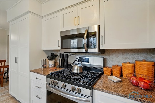 2257 N Carriage Ln, Port Clinton, OH 43452 - kitchen featuring tasteful backsplash, dark stone counters, white cabinets, and stainless steel appliances