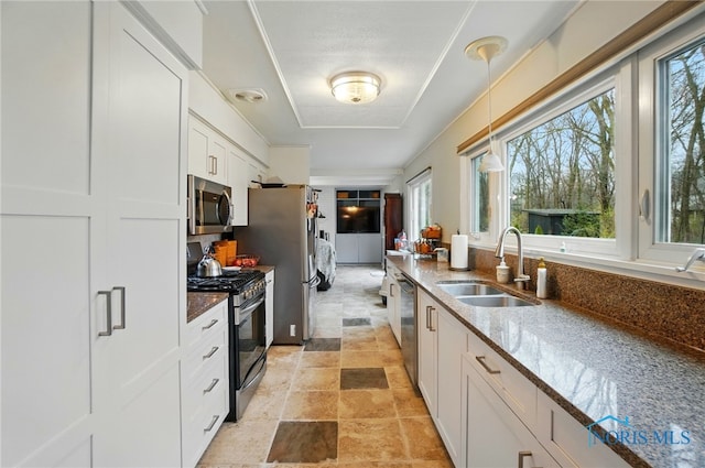 2257 N Carriage Ln, Port Clinton, OH 43452 - kitchen featuring white cabinetry, stone finish floor, dark stone counters, appliances with stainless steel finishes, and a sink