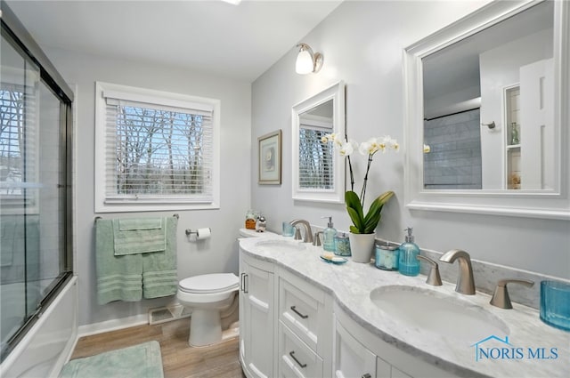 2257 N Carriage Ln, Port Clinton, OH 43452 - full bathroom featuring a sink, visible vents, toilet, and wood finished floors
