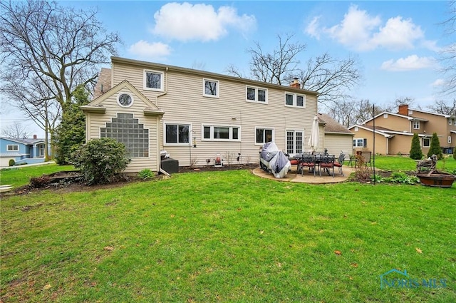 2257 N Carriage Ln, Port Clinton, OH 43452 - back of house featuring a chimney, a patio area, and a lawn