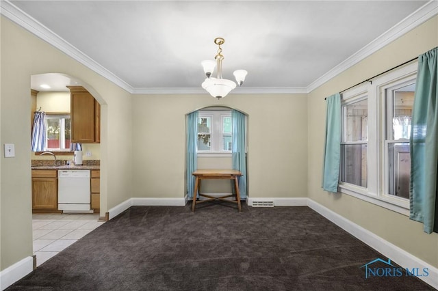 2720 106th St, Toledo, OH 43611 - unfurnished dining area featuring arched walkways, light colored carpet, and a healthy amount of sunlight