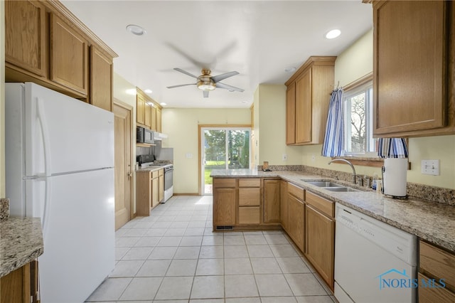 2720 106th St, Toledo, OH 43611 - kitchen with ceiling fan, white appliances, a peninsula, light tile patterned flooring, and a sink