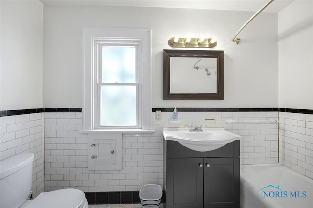 2720 106th St, Toledo, OH 43611 - full bathroom featuring vanity, a tub, a wainscoted wall, toilet, and tile walls