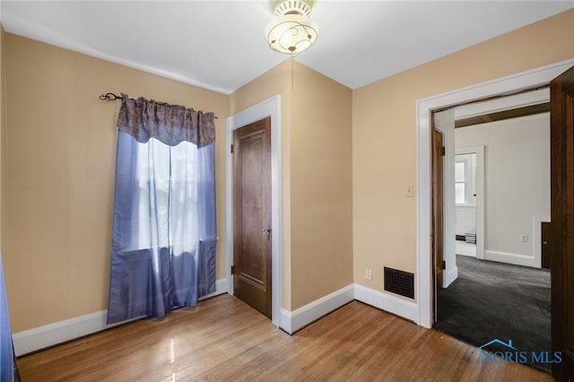 2720 106th St, Toledo, OH 43611 - unfurnished bedroom with visible vents, baseboards, and wood finished floors