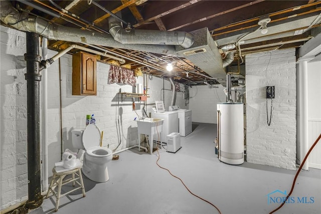 2720 106th St, Toledo, OH 43611 - below grade area featuring a sink, washing machine and clothes dryer, and gas water heater