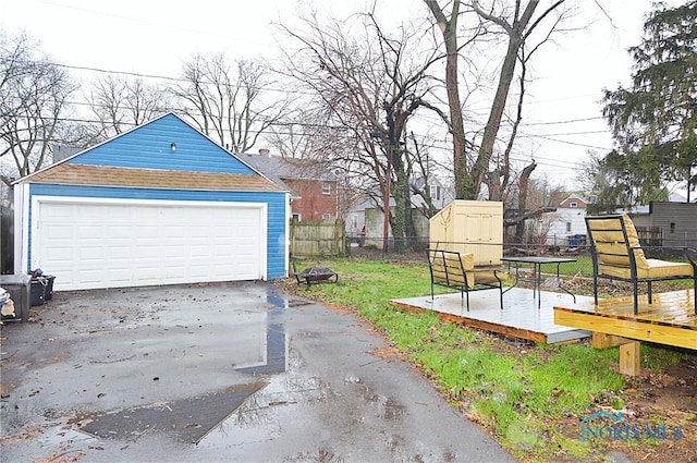detached garage featuring fence