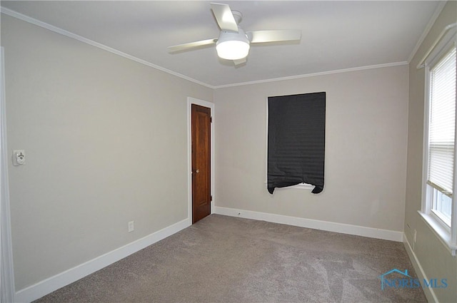 empty room with carpet flooring, ceiling fan, baseboards, and ornamental molding