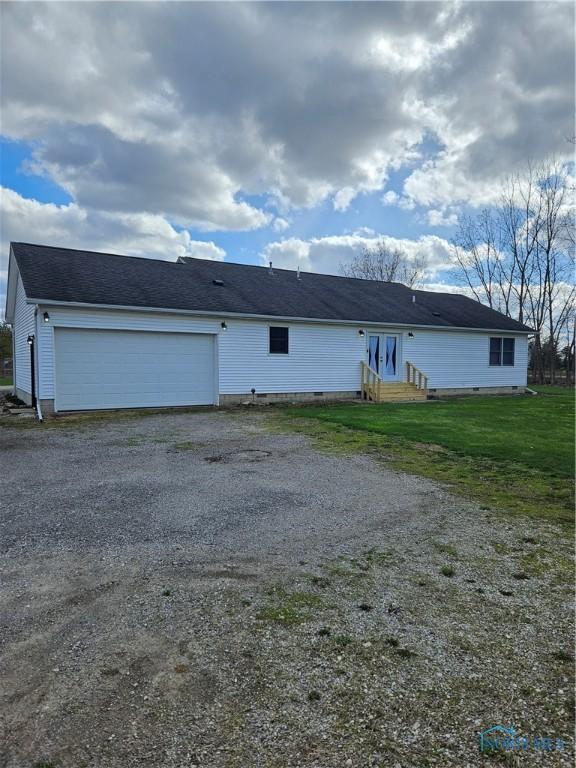 10308 Dowling Rd, Perrysburg, OH 43551 - view of front of home with a garage, gravel driveway, and entry steps