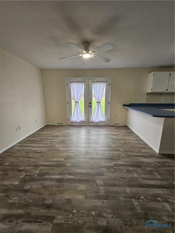 10308 Dowling Rd, Perrysburg, OH 43551 - unfurnished living room featuring dark wood-type flooring, a ceiling fan, french doors, and baseboards