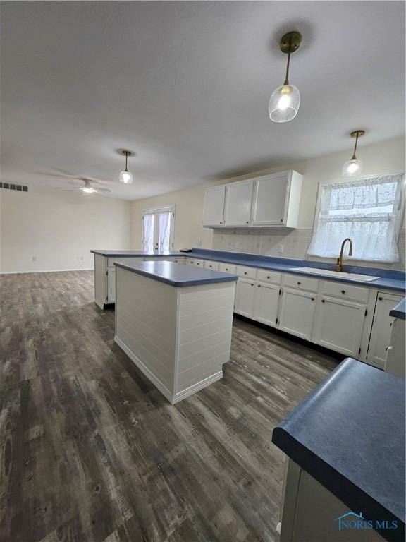 10308 Dowling Rd, Perrysburg, OH 43551 - kitchen with a sink, healthy amount of natural light, dark countertops, and white cabinetry