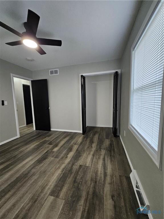 10308 Dowling Rd, Perrysburg, OH 43551 - unfurnished bedroom featuring dark wood finished floors, baseboards, ceiling fan, and a closet