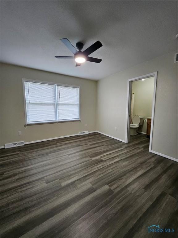 10308 Dowling Rd, Perrysburg, OH 43551 - unfurnished bedroom featuring dark wood-style floors, baseboards, ensuite bathroom, and a ceiling fan
