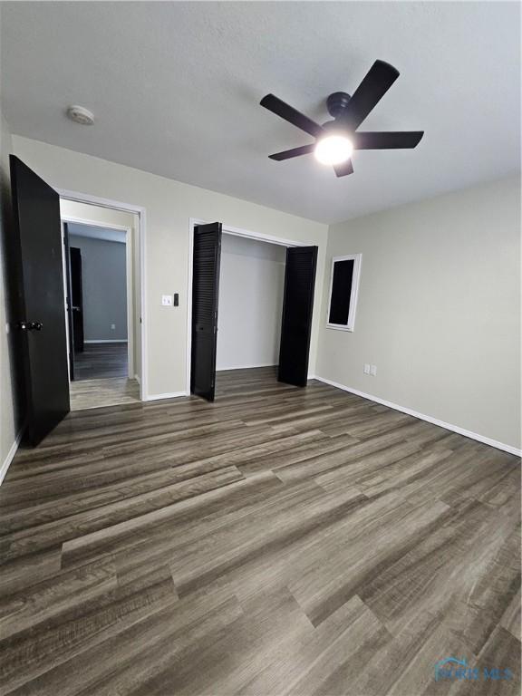 10308 Dowling Rd, Perrysburg, OH 43551 - unfurnished bedroom featuring wood finished floors, baseboards, a closet, and ceiling fan