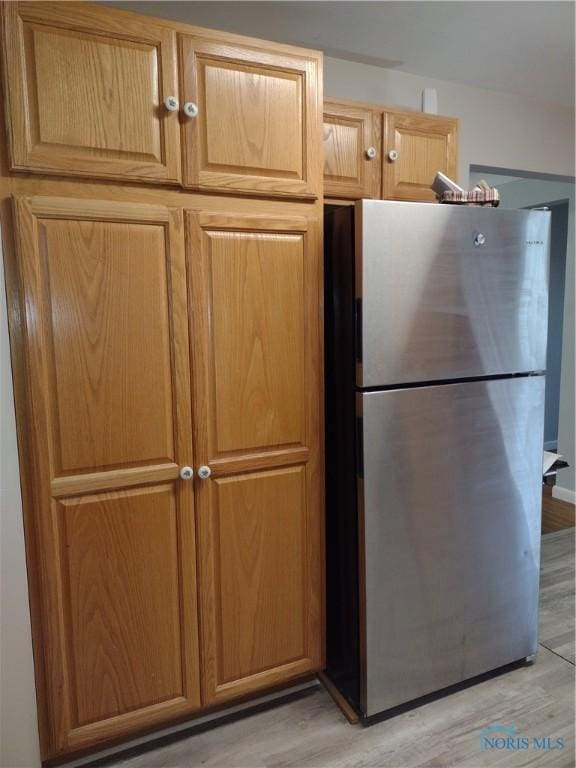 634 Cherry St, Wauseon, OH 43567 - kitchen with freestanding refrigerator and light wood-style floors