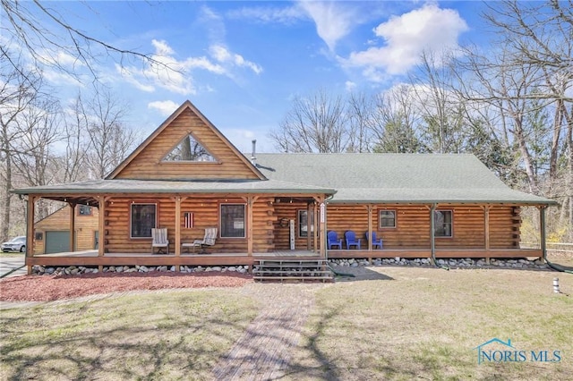 2525 N King Rd, Toledo, OH 43615 - log home with covered porch, log exterior, a front lawn, and roof with shingles