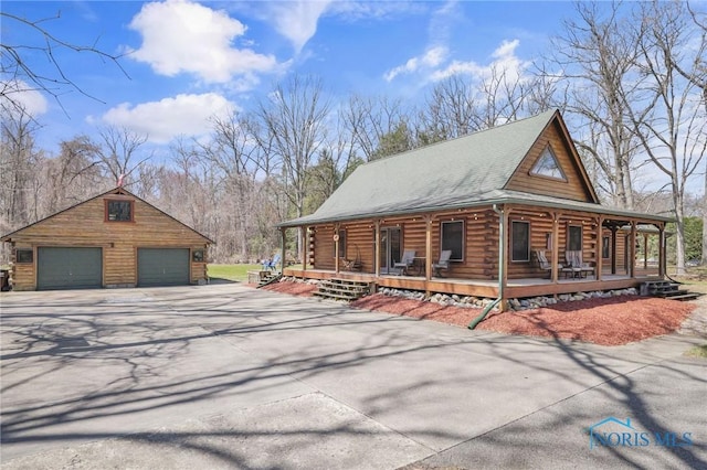 2525 N King Rd, Toledo, OH 43615 - view of property exterior with covered porch, a garage, an outbuilding, and log siding