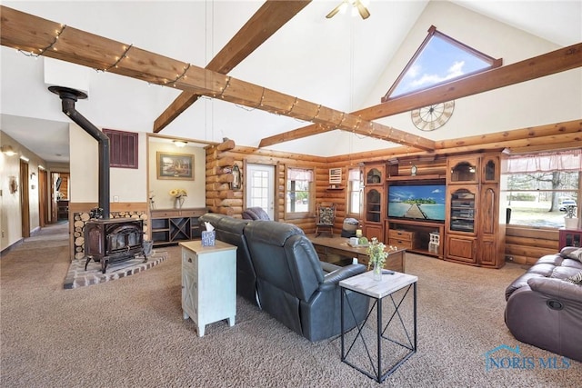 2525 N King Rd, Toledo, OH 43615 - living area featuring rustic walls, high vaulted ceiling, light colored carpet, a wood stove, and beamed ceiling