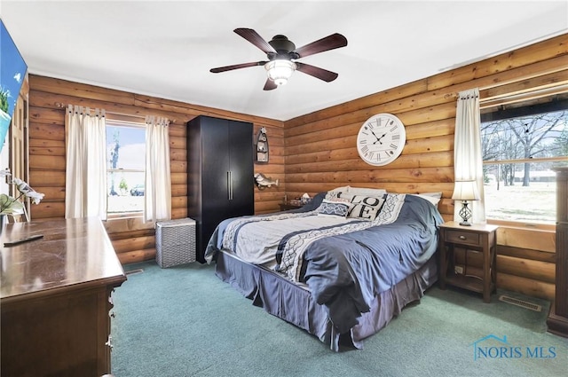 2525 N King Rd, Toledo, OH 43615 - carpeted bedroom featuring log walls and a ceiling fan