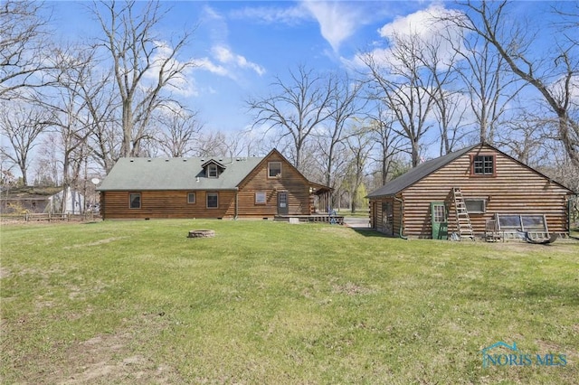 2525 N King Rd, Toledo, OH 43615 - back of property with a lawn, log siding, and an outdoor fire pit