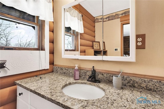 2525 N King Rd, Toledo, OH 43615 - bathroom featuring log walls and vanity