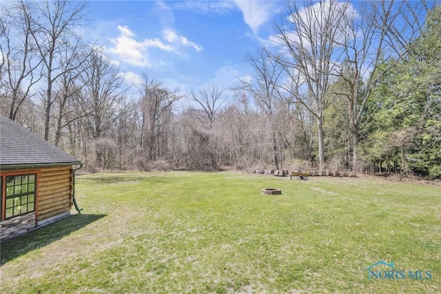 2525 N King Rd, Toledo, OH 43615 - view of green lawn with a fire pit