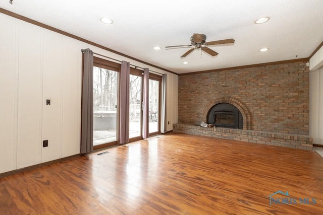 unfurnished living room with recessed lighting, wood finished floors, a ceiling fan, and crown molding