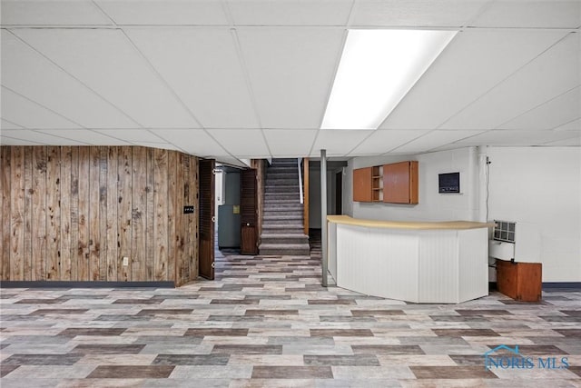 2560 Shoreland Ave, Toledo, OH 43611 - bar area with a paneled ceiling, stairway, wood finished floors, and wooden walls