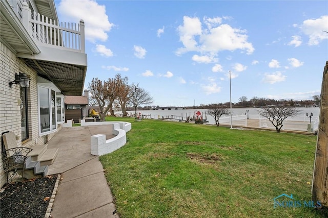 2560 Shoreland Ave, Toledo, OH 43611 - view of green lawn featuring a water view, a balcony, and a patio area