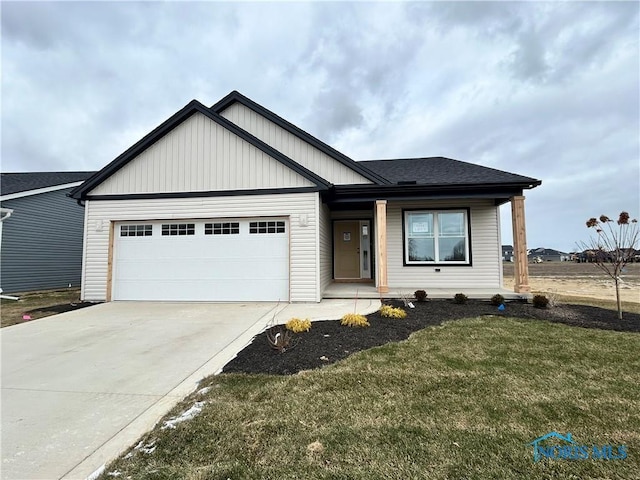 5043 Noah Ln, Oregon, OH 43616 - view of front of property with concrete driveway, a garage, and a front lawn