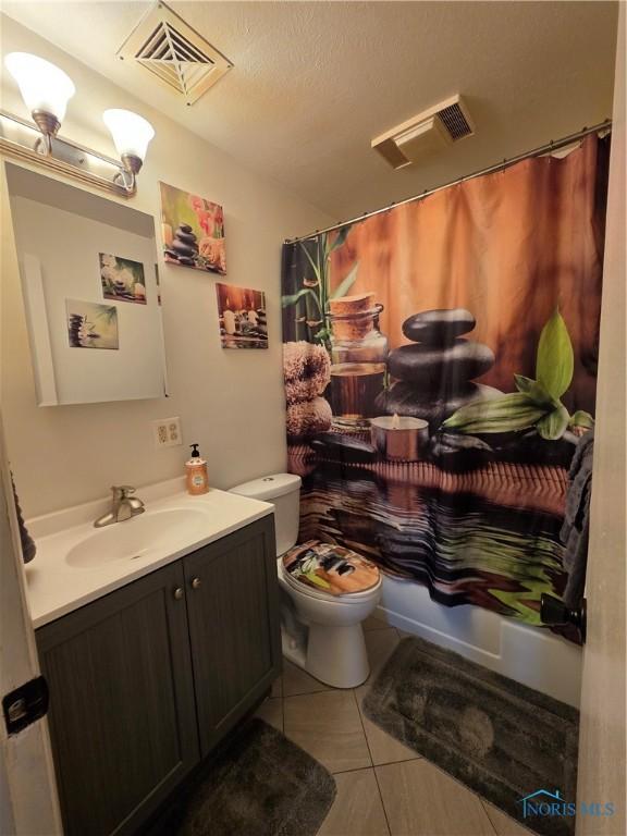 full bathroom featuring toilet, visible vents, tile patterned floors, and vanity