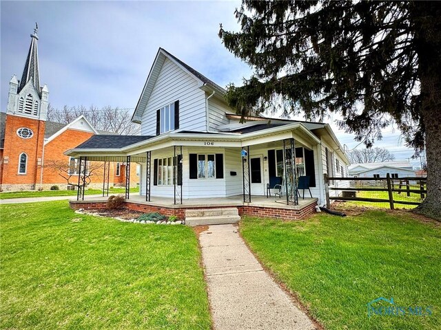 106 Adrian St, Delta, OH 43515 - view of front of home featuring a porch