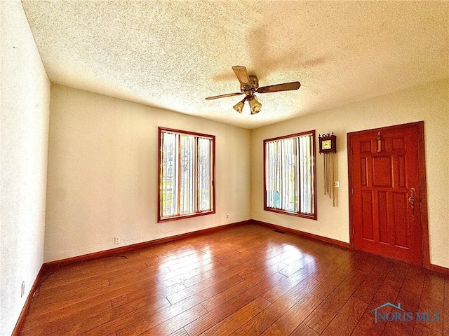 106 Adrian St, Delta, OH 43515 - empty room featuring a ceiling fan, baseboards, a textured ceiling, and wood finished floors