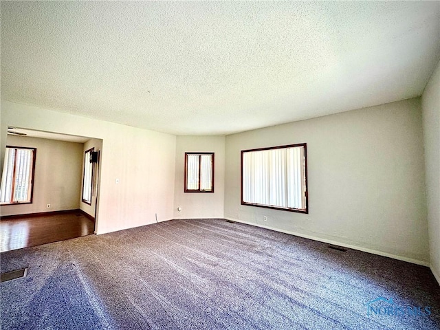 106 Adrian St, Delta, OH 43515 - carpeted spare room featuring a textured ceiling and baseboards