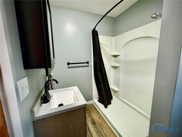 106 Adrian St, Delta, OH 43515 - bathroom featuring curtained shower, vanity, and wood finished floors