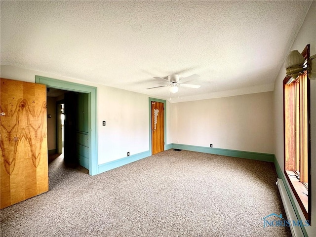 106 Adrian St, Delta, OH 43515 - unfurnished room featuring a textured ceiling, ceiling fan, a baseboard heating unit, carpet floors, and baseboards