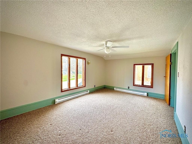 106 Adrian St, Delta, OH 43515 - spare room featuring a baseboard radiator, carpet flooring, healthy amount of natural light, and a textured ceiling