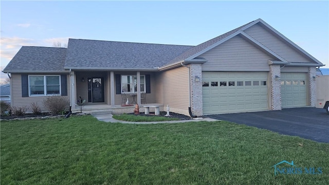 5716 Shawnee Ave, Walbridge, OH 43465 - single story home with aphalt driveway, a porch, a front yard, a garage, and a shingled roof