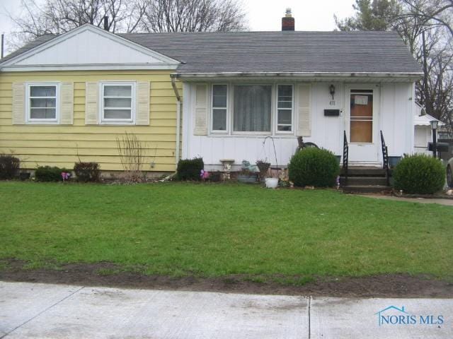 1124 Northville Dr, Toledo, OH 43612 - view of front of home with a shingled roof, a chimney, and a front lawn