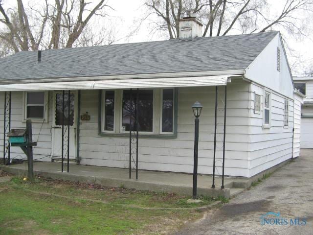 238 E Northgate Pkwy, Toledo, OH 43612 - view of front facade with a garage, a chimney, and a shingled roof