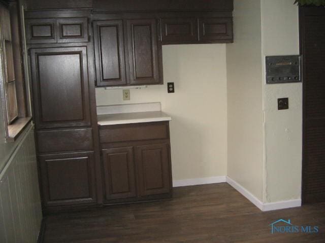 238 E Northgate Pkwy, Toledo, OH 43612 - kitchen with dark brown cabinetry, light countertops, baseboards, and dark wood finished floors