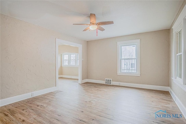 1110 Montrose Ave, Toledo, OH 43607 - empty room featuring a textured wall, visible vents, ceiling fan, and wood finished floors