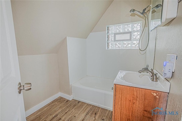 1110 Montrose Ave, Toledo, OH 43607 - bathroom with lofted ceiling, vanity, baseboards, and wood finished floors