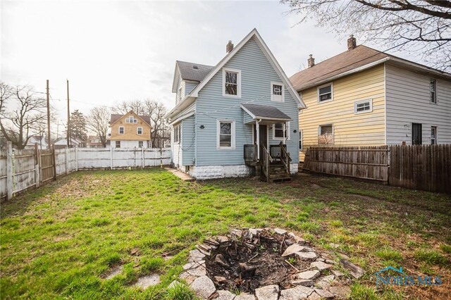 1110 Montrose Ave, Toledo, OH 43607 - rear view of property with a chimney, a fenced backyard, and a yard